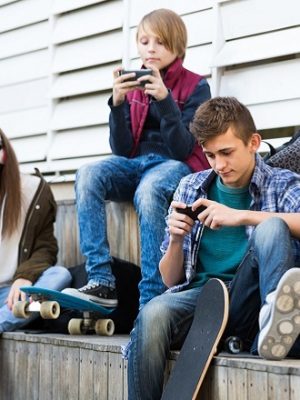 Three teenagers with smartphones