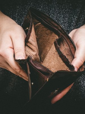 Old empty wallet in the hands .Vintage empty purse in hands of women . Poverty concept, Retirement. Special toning