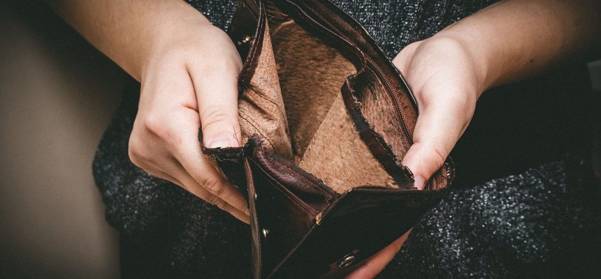 Old empty wallet in the hands .Vintage empty purse in hands of women . Poverty concept, Retirement. Special toning